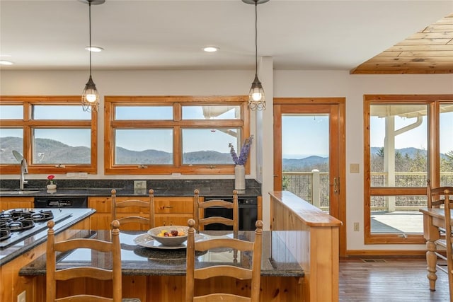 dining space with recessed lighting, a mountain view, and wood finished floors