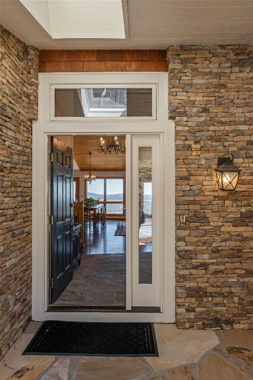 doorway to property featuring stone siding