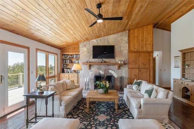 living area featuring built in features, wood finished floors, a fireplace, ceiling fan, and wood ceiling