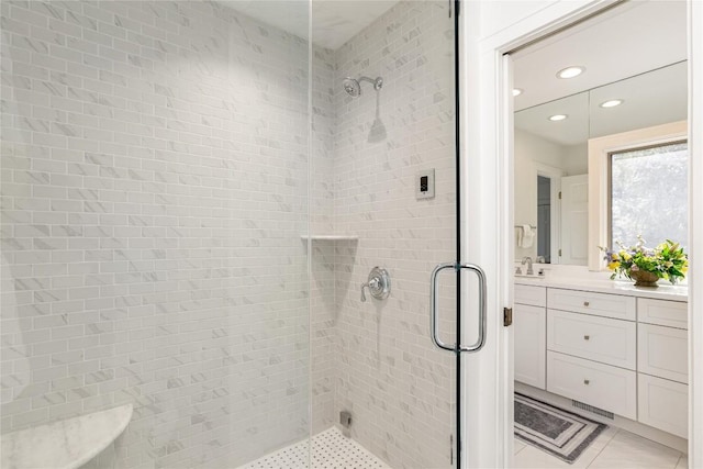 bathroom with tile patterned floors, a shower stall, and vanity