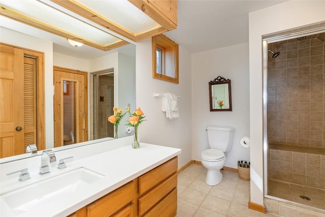 full bath featuring tile patterned floors, baseboards, toilet, and a shower stall