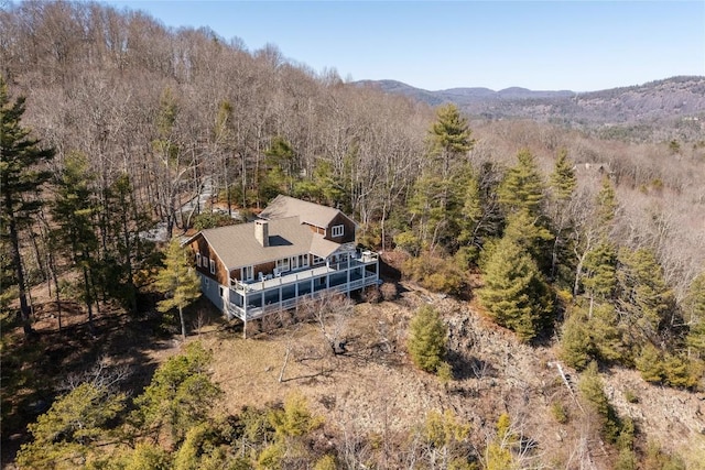 birds eye view of property featuring a mountain view and a view of trees