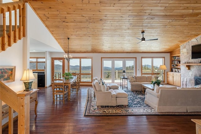 living area with wood ceiling, wood finished floors, stairs, and ceiling fan with notable chandelier