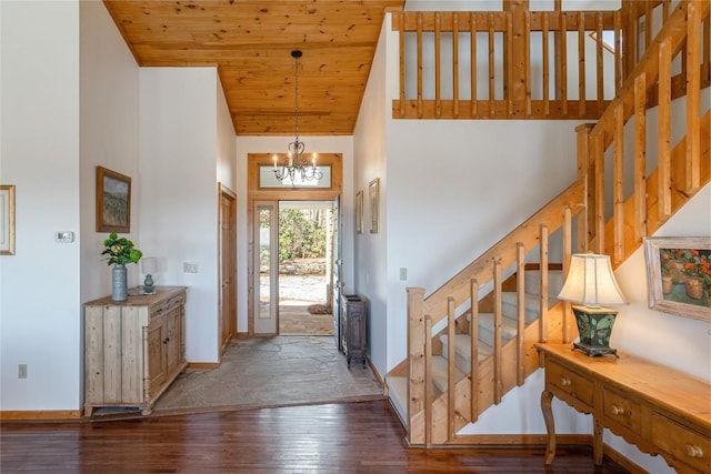 foyer entrance with stairway, high vaulted ceiling, hardwood / wood-style flooring, wooden ceiling, and a notable chandelier