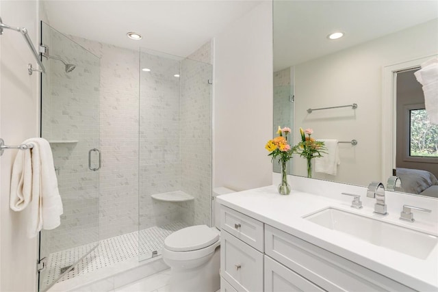 ensuite bathroom featuring toilet, recessed lighting, connected bathroom, a shower stall, and vanity