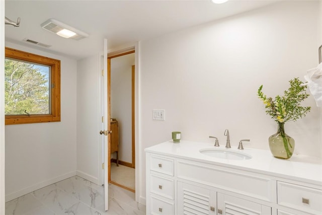 bathroom featuring vanity, baseboards, visible vents, and marble finish floor