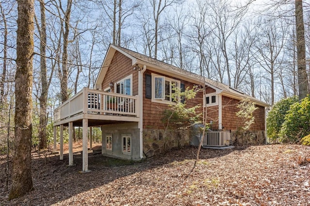 view of side of home with cooling unit and a deck