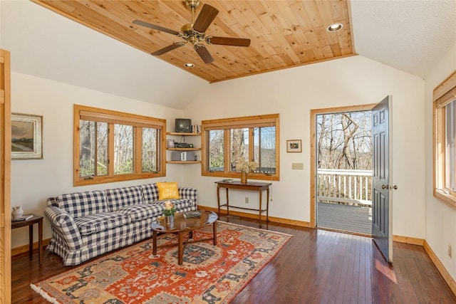 living room featuring baseboards, ceiling fan, dark wood finished floors, and vaulted ceiling