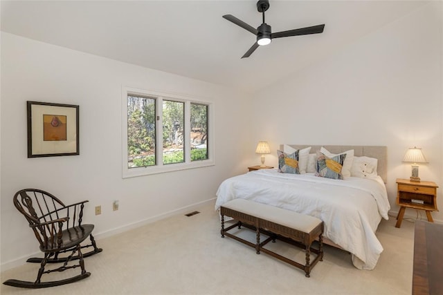 bedroom featuring visible vents, light carpet, baseboards, ceiling fan, and vaulted ceiling