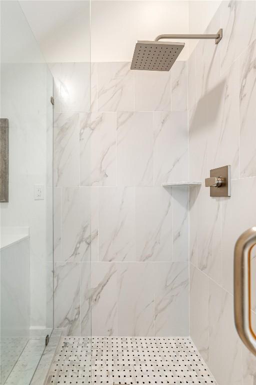 full bath featuring a marble finish shower