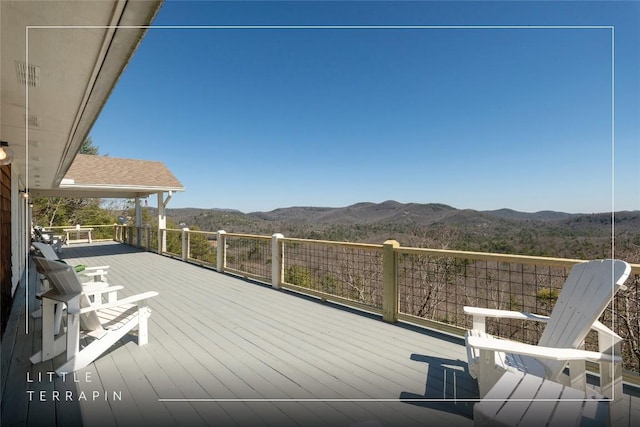 wooden deck featuring a mountain view