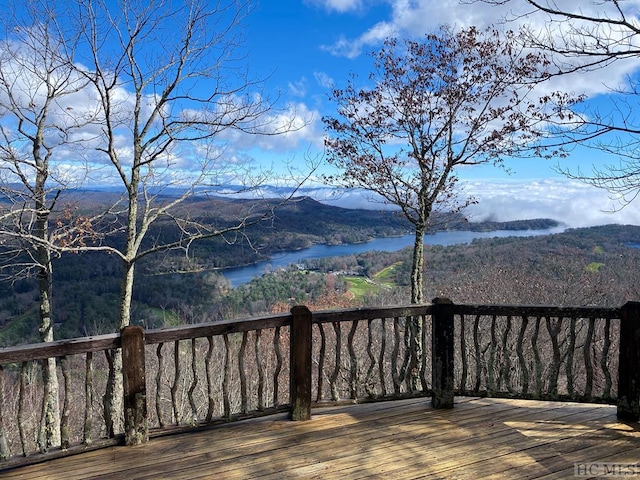 deck with a water and mountain view