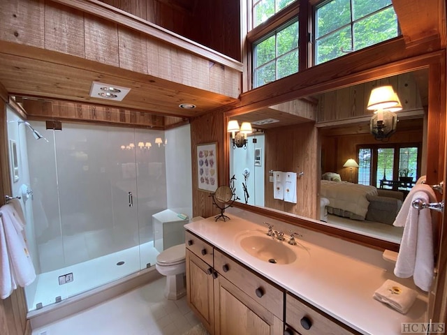 bathroom featuring tile patterned flooring, wooden walls, an enclosed shower, vanity, and toilet