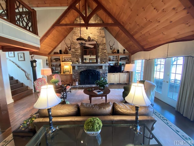 living room with high vaulted ceiling, wooden ceiling, beamed ceiling, a fireplace, and hardwood / wood-style floors