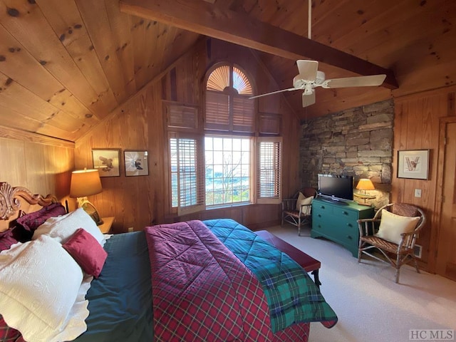 carpeted bedroom with vaulted ceiling with beams, wooden ceiling, ceiling fan, and wood walls