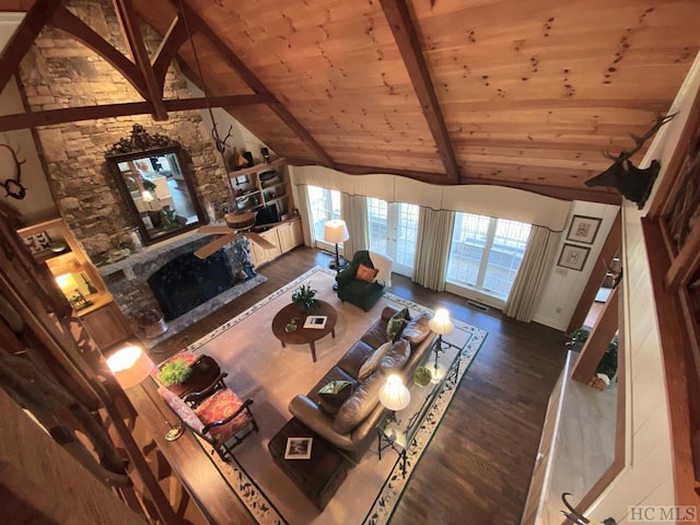 unfurnished living room with beam ceiling, high vaulted ceiling, a fireplace, dark hardwood / wood-style flooring, and wooden ceiling