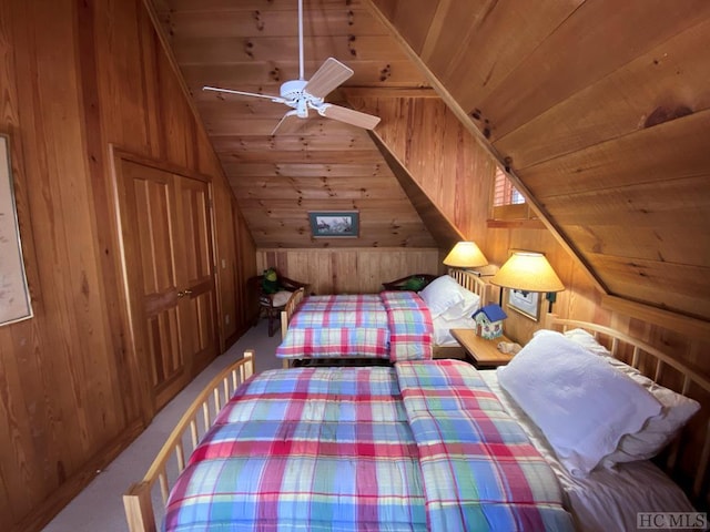 unfurnished bedroom featuring wood walls, lofted ceiling, carpet, ceiling fan, and wood ceiling