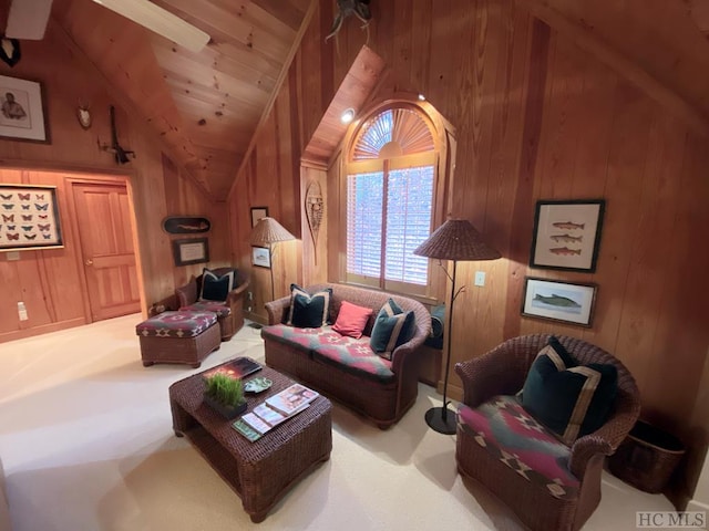 carpeted living room featuring lofted ceiling, wooden ceiling, and wood walls