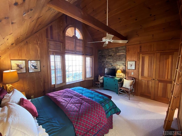 carpeted bedroom with vaulted ceiling with beams, wood ceiling, wooden walls, and ceiling fan