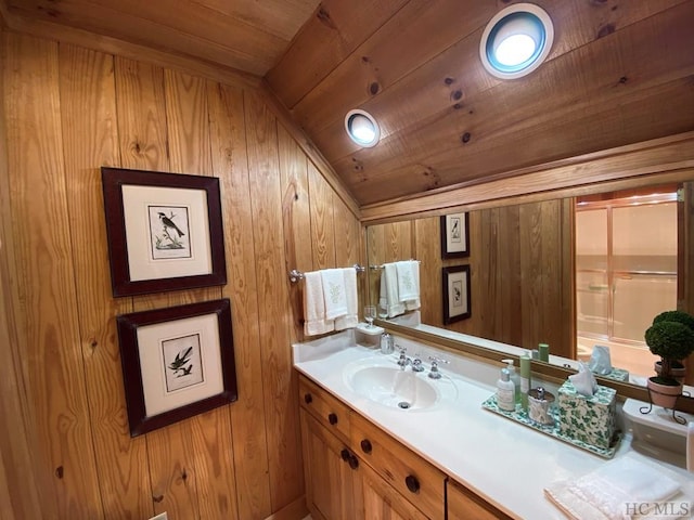 bathroom with vanity, lofted ceiling, wooden ceiling, and wooden walls