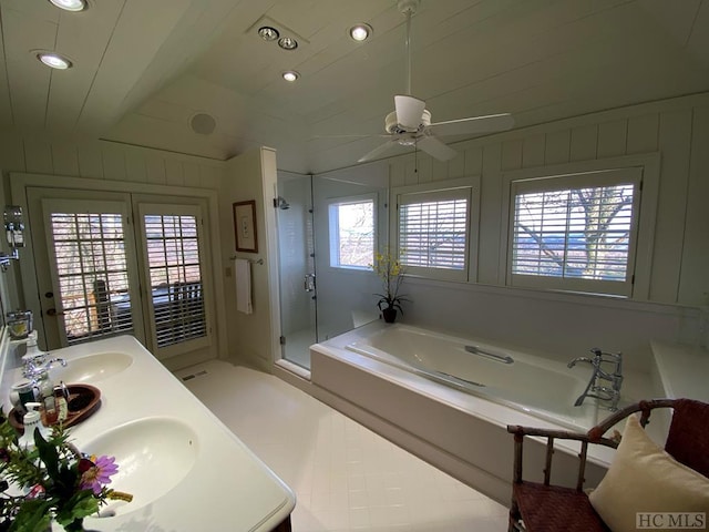 bathroom with lofted ceiling, vanity, independent shower and bath, and wood walls