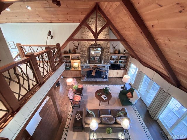 living room with beamed ceiling, high vaulted ceiling, hardwood / wood-style floors, and wooden ceiling