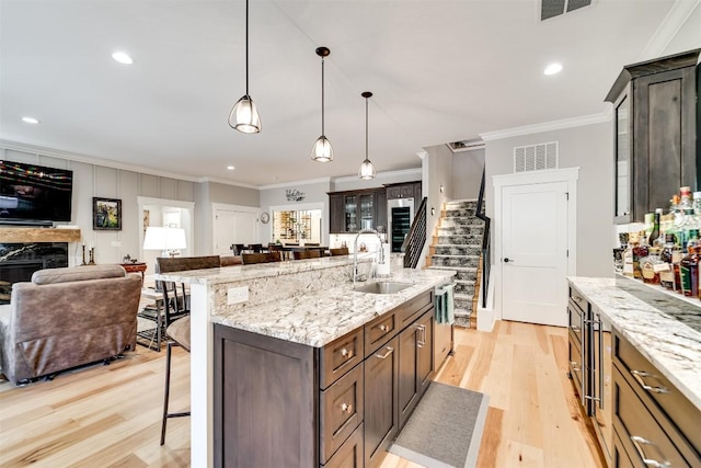 1132 Southshore Dr, Tuckasegee, NC 28783 - kitchen featuring a premium fireplace, a sink, visible vents, and a kitchen breakfast bar