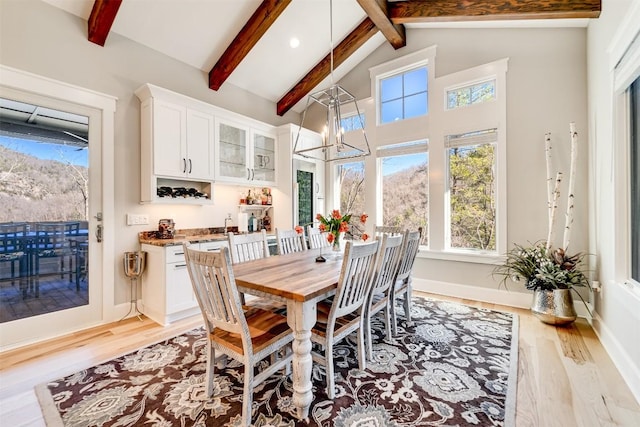 1132 Southshore Dr, Tuckasegee, NC 28783 - dining space with light wood finished floors, baseboards, a chandelier, beamed ceiling, and high vaulted ceiling