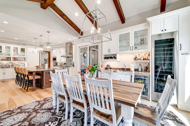 1132 Southshore Dr, Tuckasegee, NC 28783 - dining space with wine cooler, indoor wet bar, beamed ceiling, and light wood finished floors