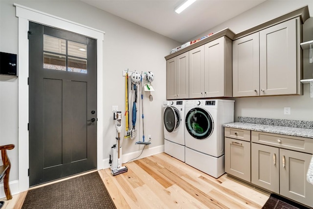 1132 Southshore Dr, Tuckasegee, NC 28783 - washroom with cabinet space, baseboards, separate washer and dryer, and light wood finished floors