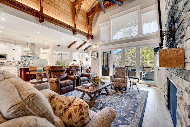 1132 Southshore Dr, Tuckasegee, NC 28783 - living room with high vaulted ceiling, beam ceiling, wood-type flooring, and a stone fireplace