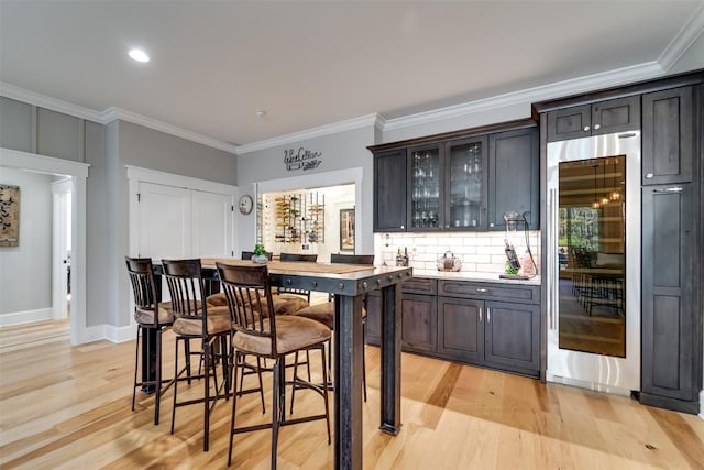 1132 Southshore Dr, Tuckasegee, NC 28783 - bar with built in fridge, tasteful backsplash, ornamental molding, light wood-style floors, and baseboards
