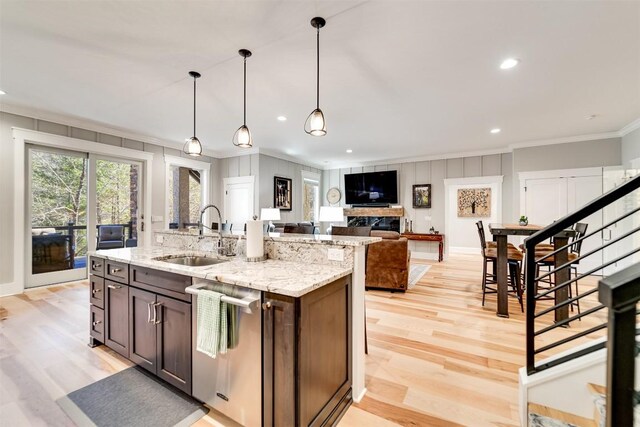 1132 Southshore Dr, Tuckasegee, NC 28783 - kitchen with dishwasher, ornamental molding, a kitchen island with sink, light wood-type flooring, and a sink
