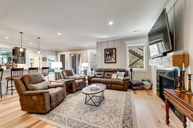 1132 Southshore Dr, Tuckasegee, NC 28783 - living area with light wood-type flooring, a premium fireplace, ornamental molding, and recessed lighting