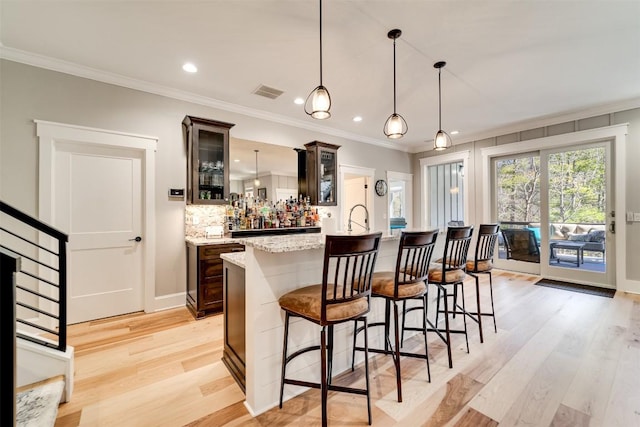 1132 Southshore Dr, Tuckasegee, NC 28783 - bar featuring tasteful backsplash, visible vents, ornamental molding, light wood-type flooring, and bar area