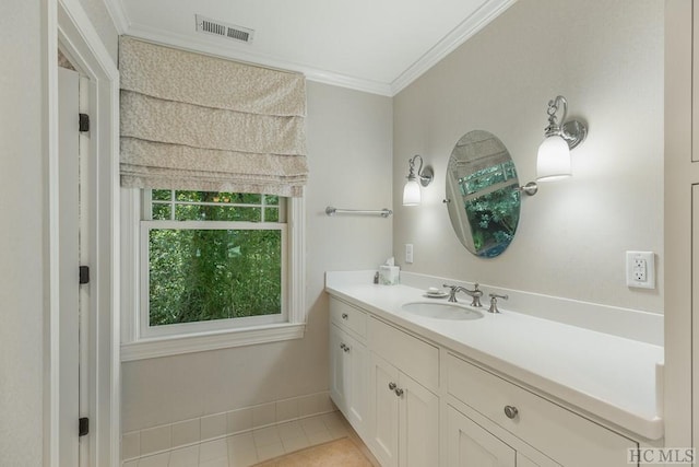 bathroom with crown molding, tile patterned flooring, and vanity