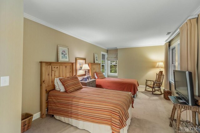 carpeted bedroom featuring crown molding