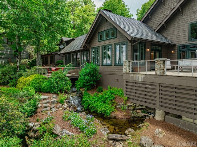 rear view of house featuring a sunroom