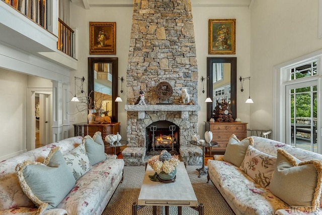 living room featuring a towering ceiling and a fireplace