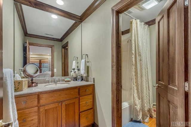 bathroom featuring crown molding, wood-type flooring, shower / bathtub combination with curtain, and vanity