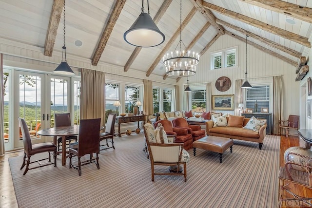 sunroom featuring an inviting chandelier, lofted ceiling with beams, and french doors