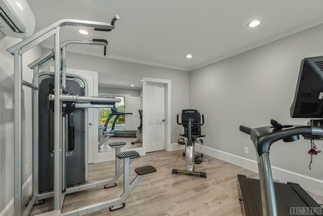 workout area featuring crown molding, light wood-type flooring, and a wall unit AC