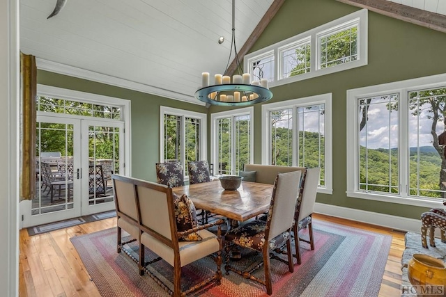 sunroom with a chandelier, french doors, and vaulted ceiling