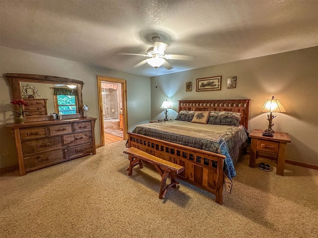 bedroom with ensuite bathroom, carpet floors, a textured ceiling, and ceiling fan