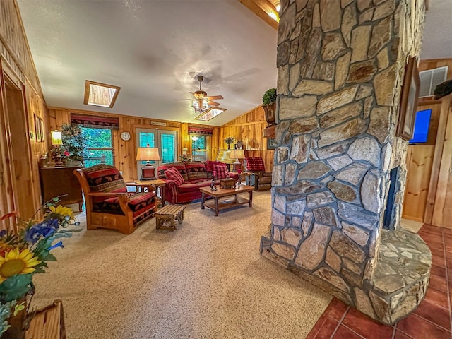 tiled living room featuring wood walls, vaulted ceiling, and a ceiling fan