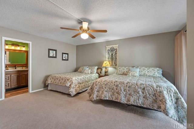 bedroom featuring carpet, a textured ceiling, ceiling fan, and ensuite bath