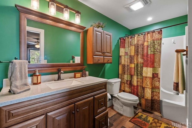 full bathroom featuring shower / tub combo with curtain, vanity, hardwood / wood-style flooring, and toilet