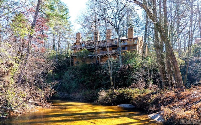 rear view of house featuring a water view