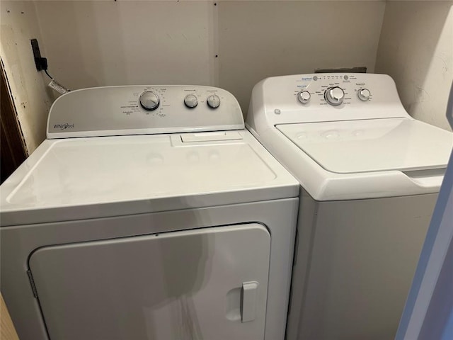 clothes washing area featuring independent washer and dryer