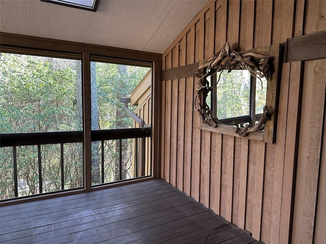 unfurnished sunroom featuring lofted ceiling